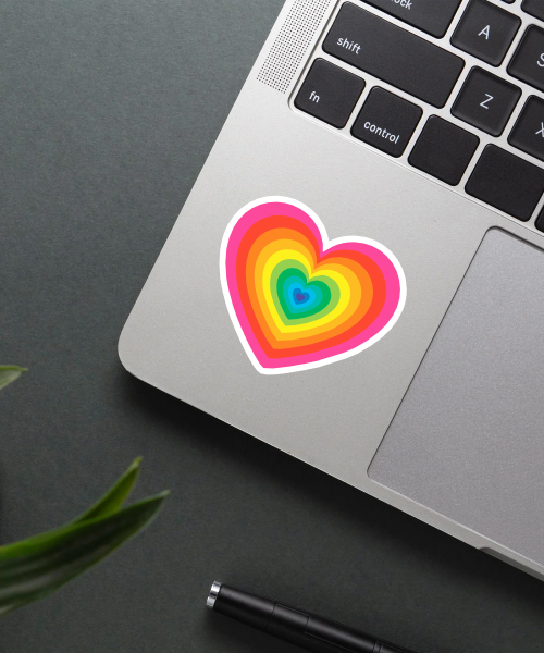 Mockup showing the colorful heart sticker applied on a laptop.
