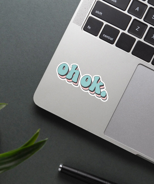 Mockup of Oh Ok Sticker on a laptop.