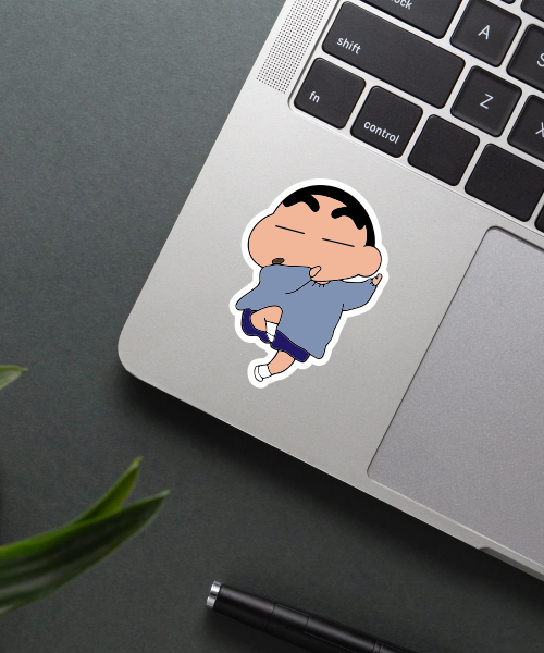 shinchan dancing sticker on laptop surface showing playful pose and bright colors