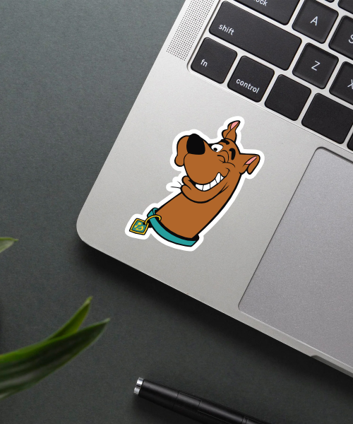 scooby doo cartoon sticker on laptop showing winking dog face with blue collar