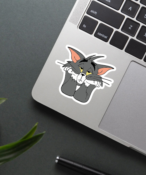 sad tom cartoon sticker on laptop showing grey cat with bored expression resting face