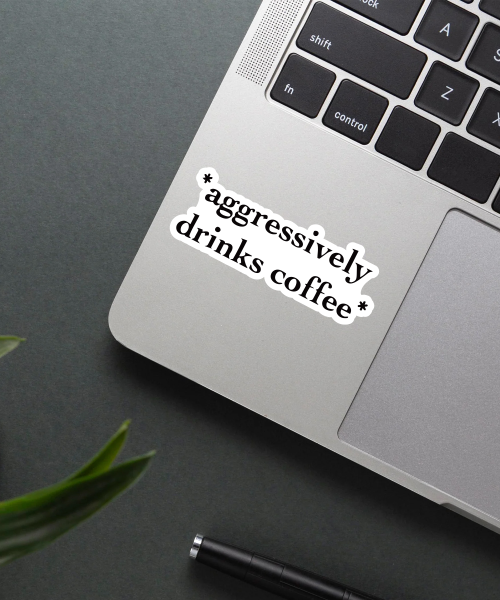 Aggressively Drinks Coffee Sticker on a laptop.