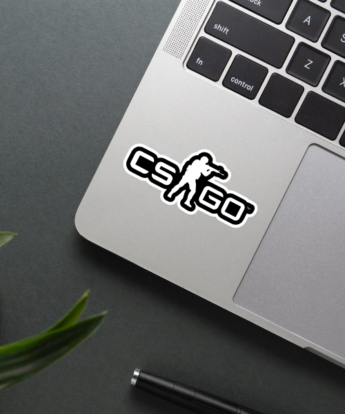 CS GO sticker on a laptop surface.