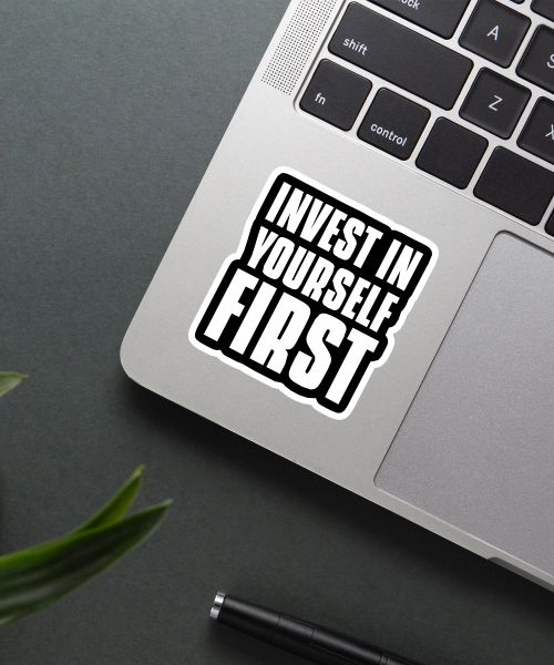 Mockup of Invest in Yourself First Sticker on a laptop.