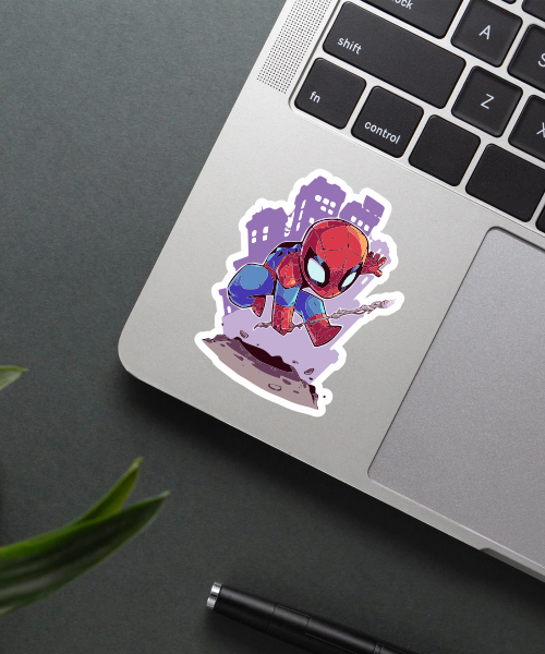 spider man sticker on laptop showing cartoon spider man jumping with web and city background
