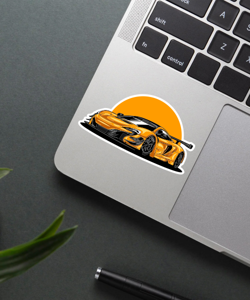 yellow pagani huayra car sticker on laptop surface showing sleek supercar design