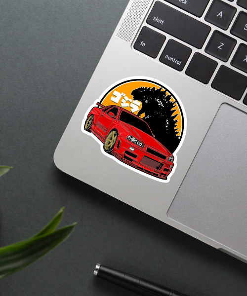 nissan skyline gt r car sticker on laptop surface showing red car and godzilla design