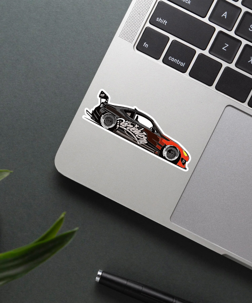 subaru brz car sticker on laptop surface showing black red racing car design