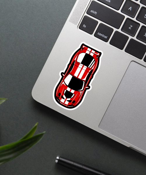 ford gt40 sticker on laptop surface showing red racing car with white stripes