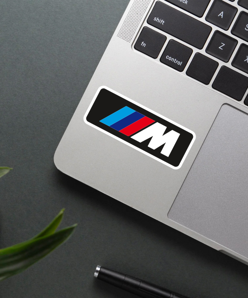 bmw motors sticker on laptop surface showing m logo with colored stripes