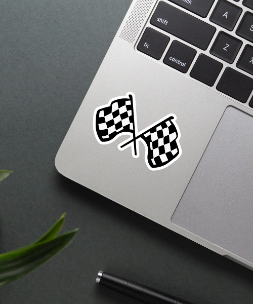race sticker on laptop surface showing crossed checkered flags