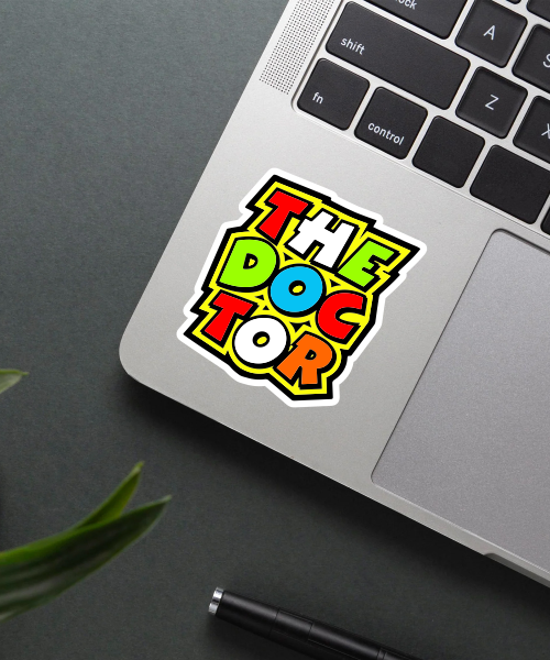 The Doctor sticker on laptop surface showing colorful bold letters and vibrant look