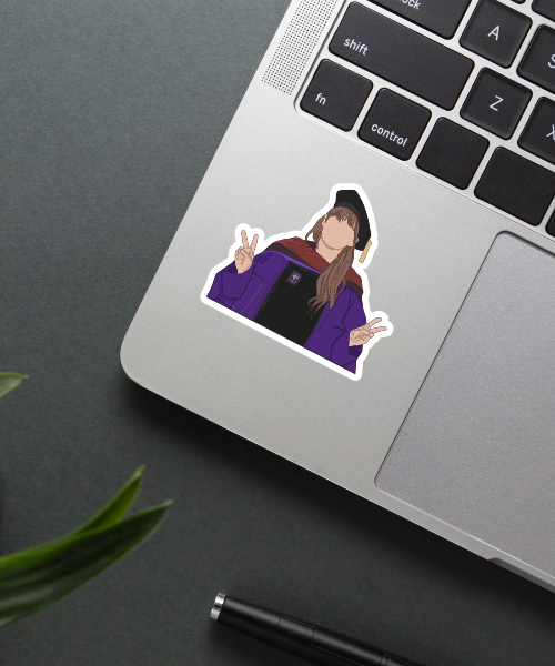 dr taylor swift sticker on laptop surface showing graduation outfit and peace signs