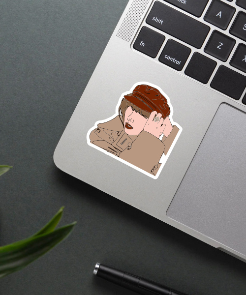 red taylors version sticker on phone surface showing brown coat and hat style