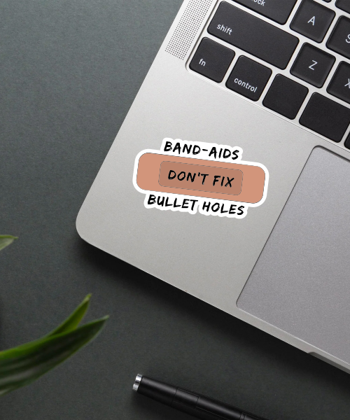 band aids don't fix bullet holes sticker on phone surface showing brown band aid with text