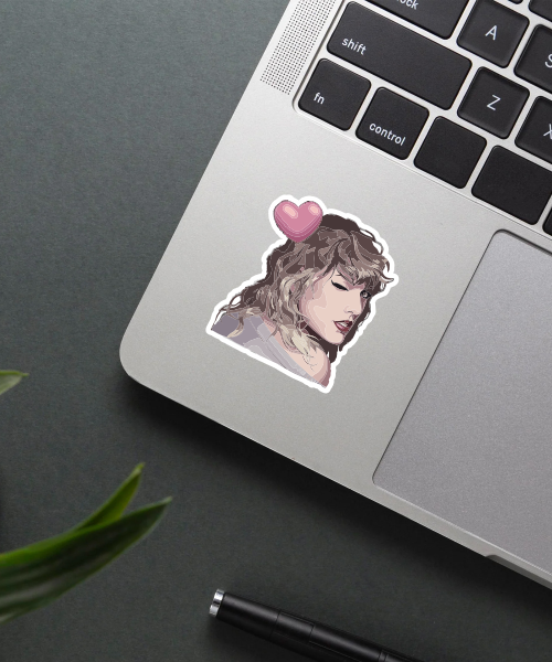 taylor swift sticker on laptop showing winking face and pink heart
