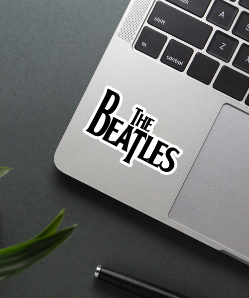 The Beatles music sticker on a laptop showing the classic black logo with white outline