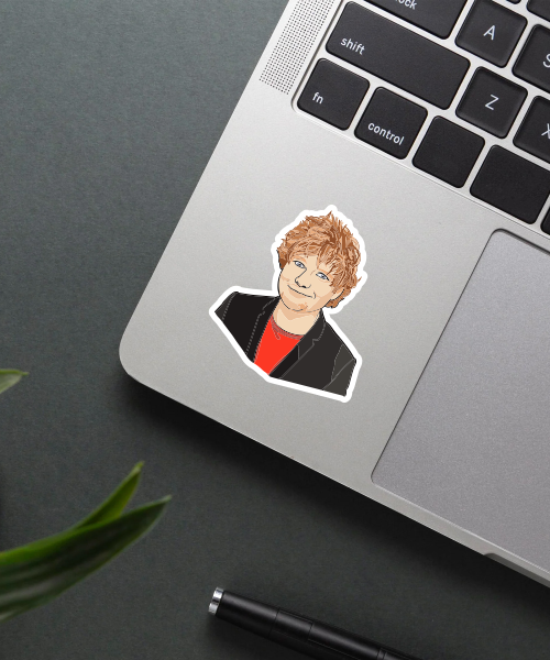 ed sheeran sticker on laptop surface showing detailed portrait with red hair