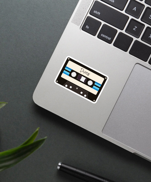 divide cassette tape sticker with retro style on laptop surface