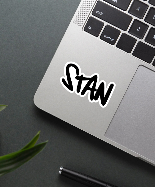 stan music sticker on phone case surface showing bold black and white lettering