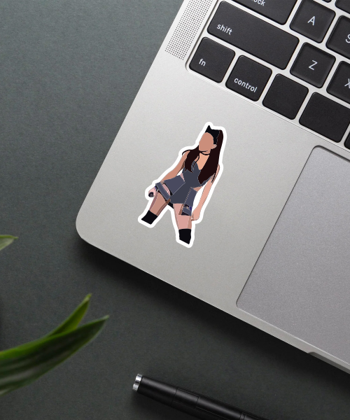 ariana grande concert sticker on laptop surface showing black outfit and stage look