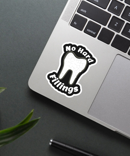 no hard fillings sticker on laptop surface showing cracked tooth and text