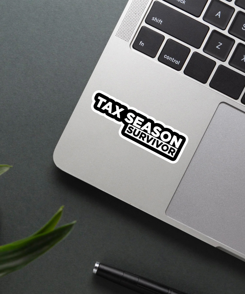 tax season survivor sticker on laptop surface showing bold black and white text