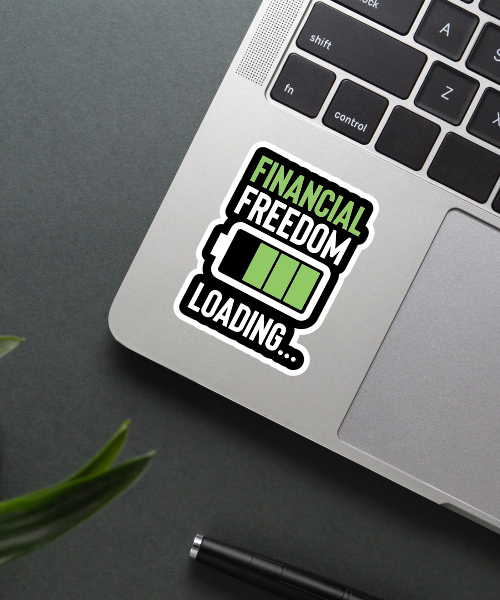 financial freedom sticker on laptop surface showing battery charge symbol and text