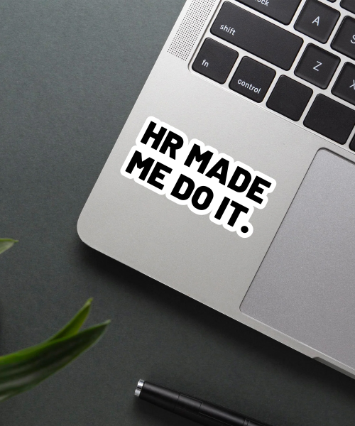 hr made me do it sticker on laptop surface showing bold black text
