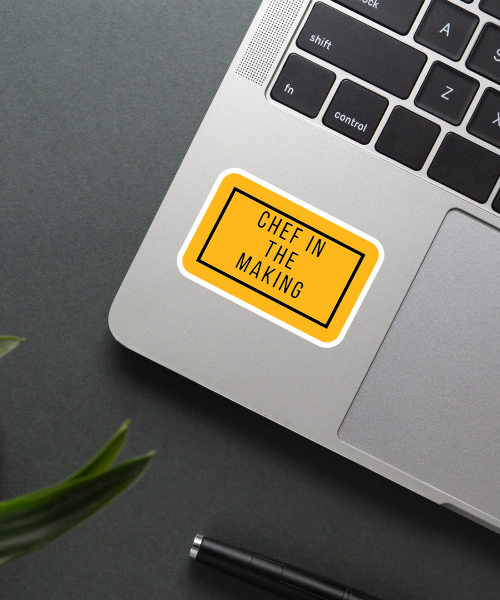 chef in the making sticker on laptop surface showing yellow black minimal style
