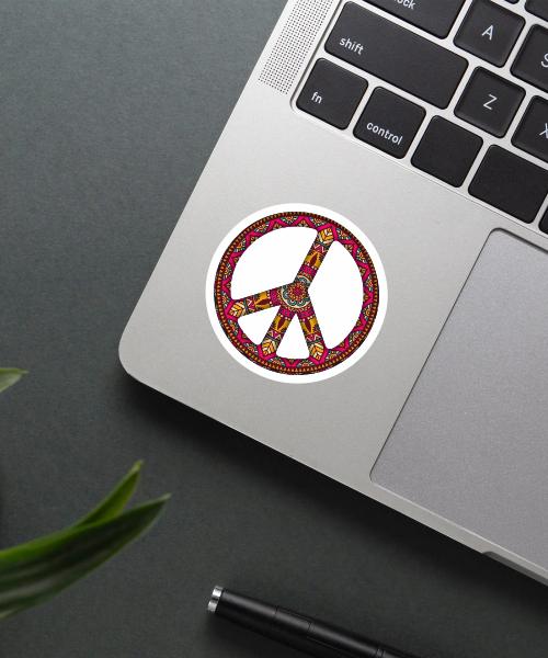 peace sticker on laptop surface showing colorful mandala pattern peace symbol