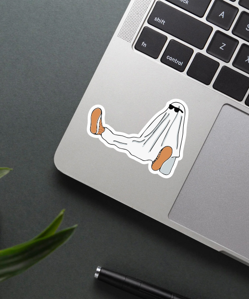 cool ghost sticker on laptop surface showing relaxed ghost with sunglasses and brown shoes