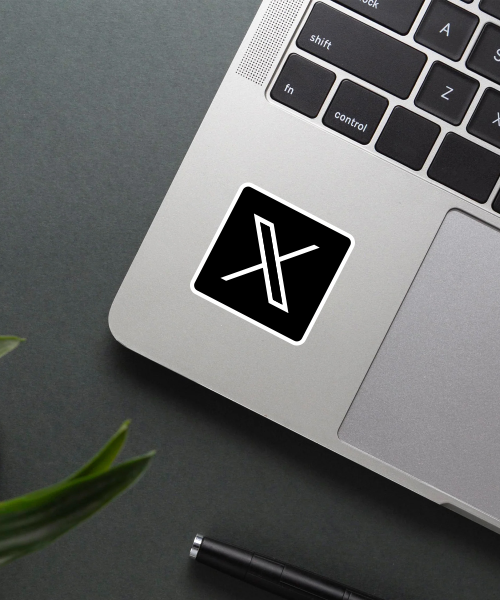 x twitter logo sticker on phone surface showing sleek black and white design with smooth finish