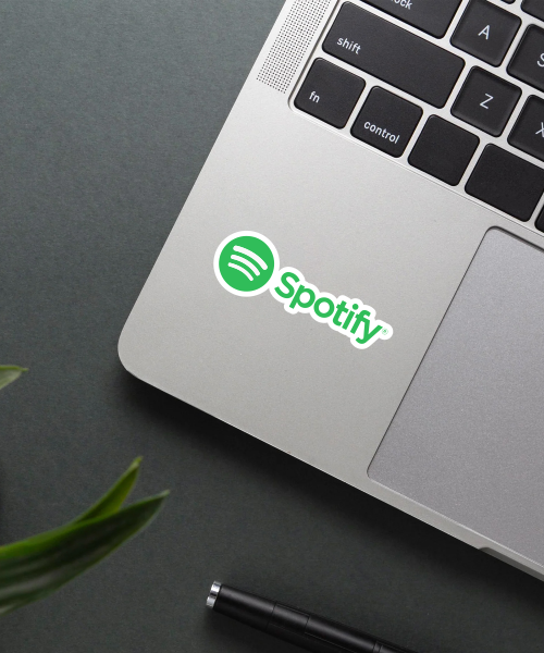 spotify name logo vinyl sticker on laptop surface showing bright green and white colors