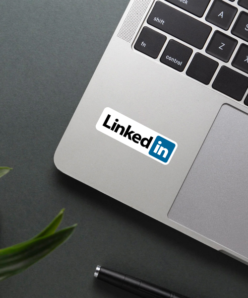 linkedin logo sticker on laptop surface showing official black and blue colors