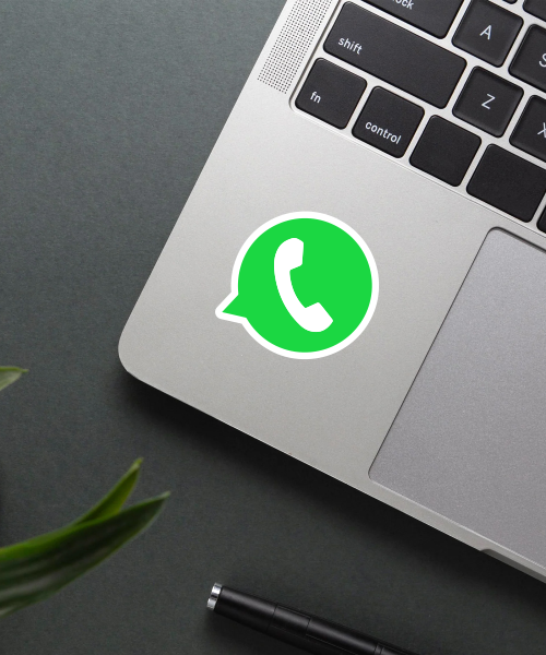 whatsapp logo sticker on phone surface showing bright green chat bubble and white phone icon