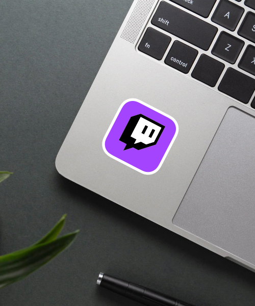 twitch logo sticker on laptop surface showing purple background and white chat bubble icon