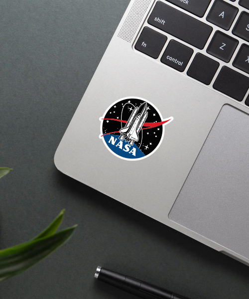 nasa space shuttle vinyl sticker on laptop surface showing detailed shuttle and colors