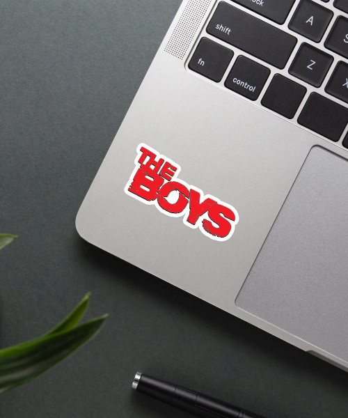 the boys sticker on laptop surface showing bold red distressed text