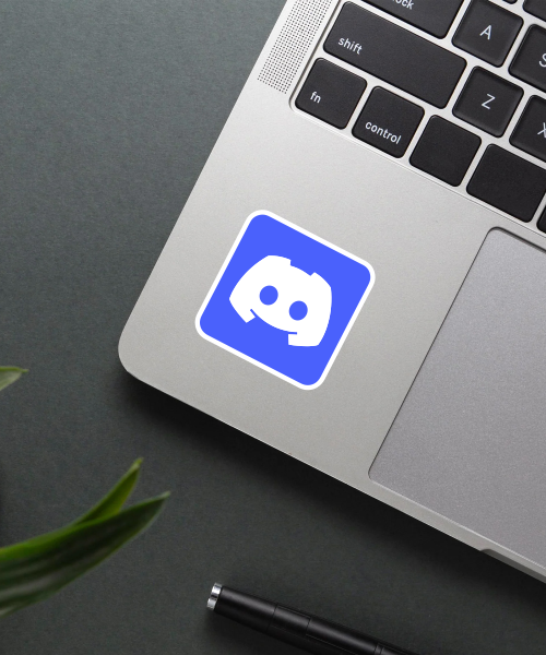 discord logo sticker on gaming laptop showing blue background and white logo