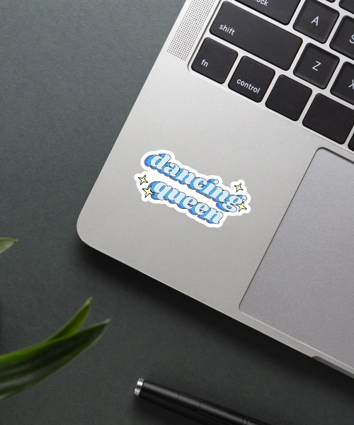 dancing queen sticker on laptop surface showing blue 3d text and sparkle accents