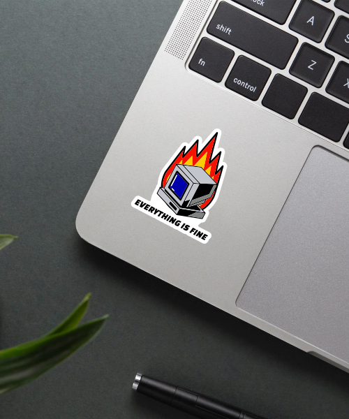 everything is fine sticker on laptop showing retro computer with flames and text