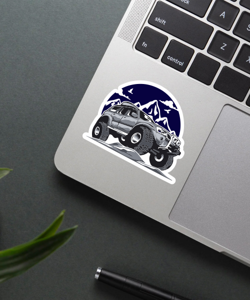 Mockup of Off Road Adventure sticker showing SUV climbing rocks with mountain background, perfect for travel lovers.