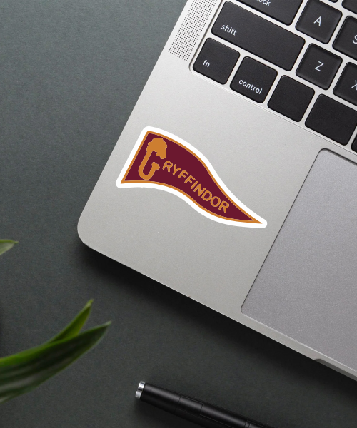 gryffindor flag sticker on laptop surface showing maroon and yellow colors