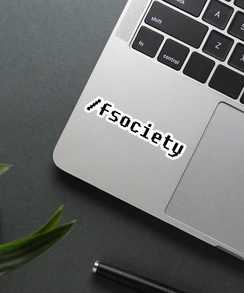 fsociety sticker on laptop surface showing black and white hacker logo