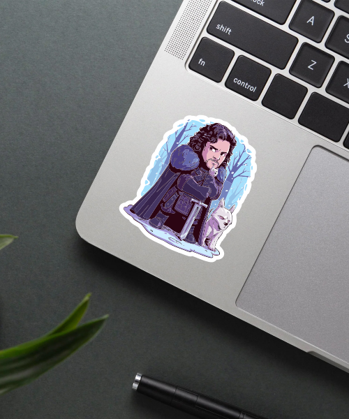 john snow cartoon sticker on laptop surface showing chibi character and direwolf