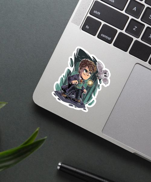 harry potter sticker on laptop surface showing chibi harry with wand and owl