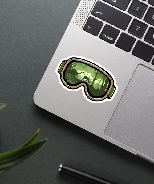 Mockup of ski goggles travel sticker on a laptop showing forest deer reflection