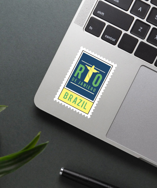 Mockup showing Rio De Janeiro Brazil travel sticker on laptop with Christ the Redeemer green yellow blue design.