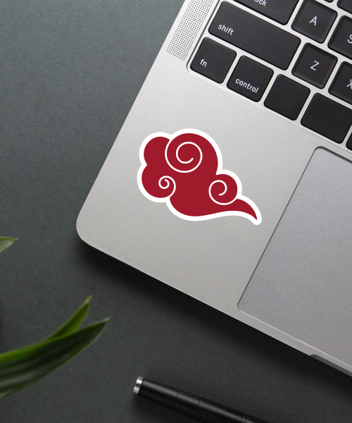 Akatsuki naruto sticker on laptop surface showing red cloud symbol on white background